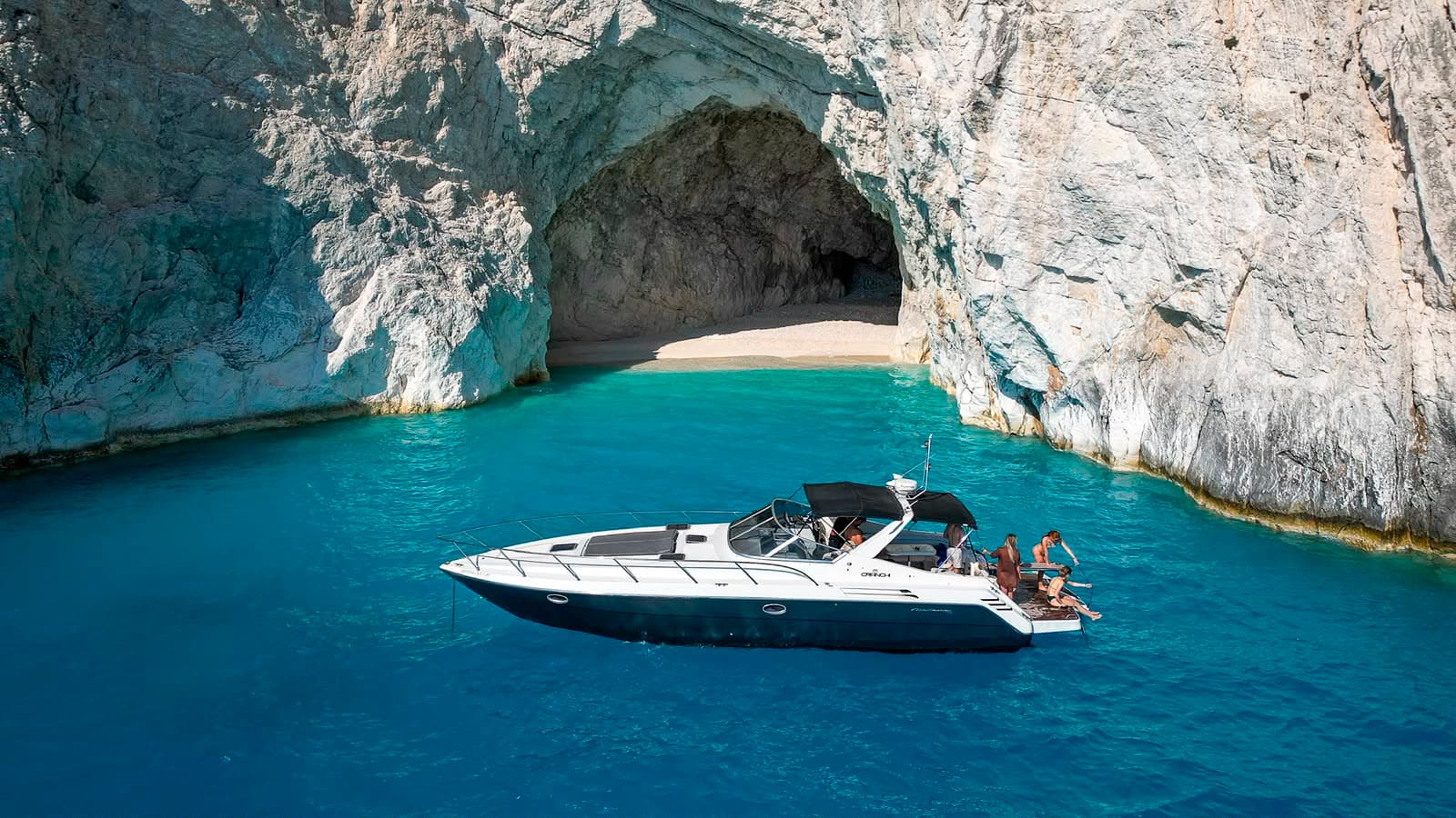 Luxury yacht anchored beside a sea cave in Zakynthos